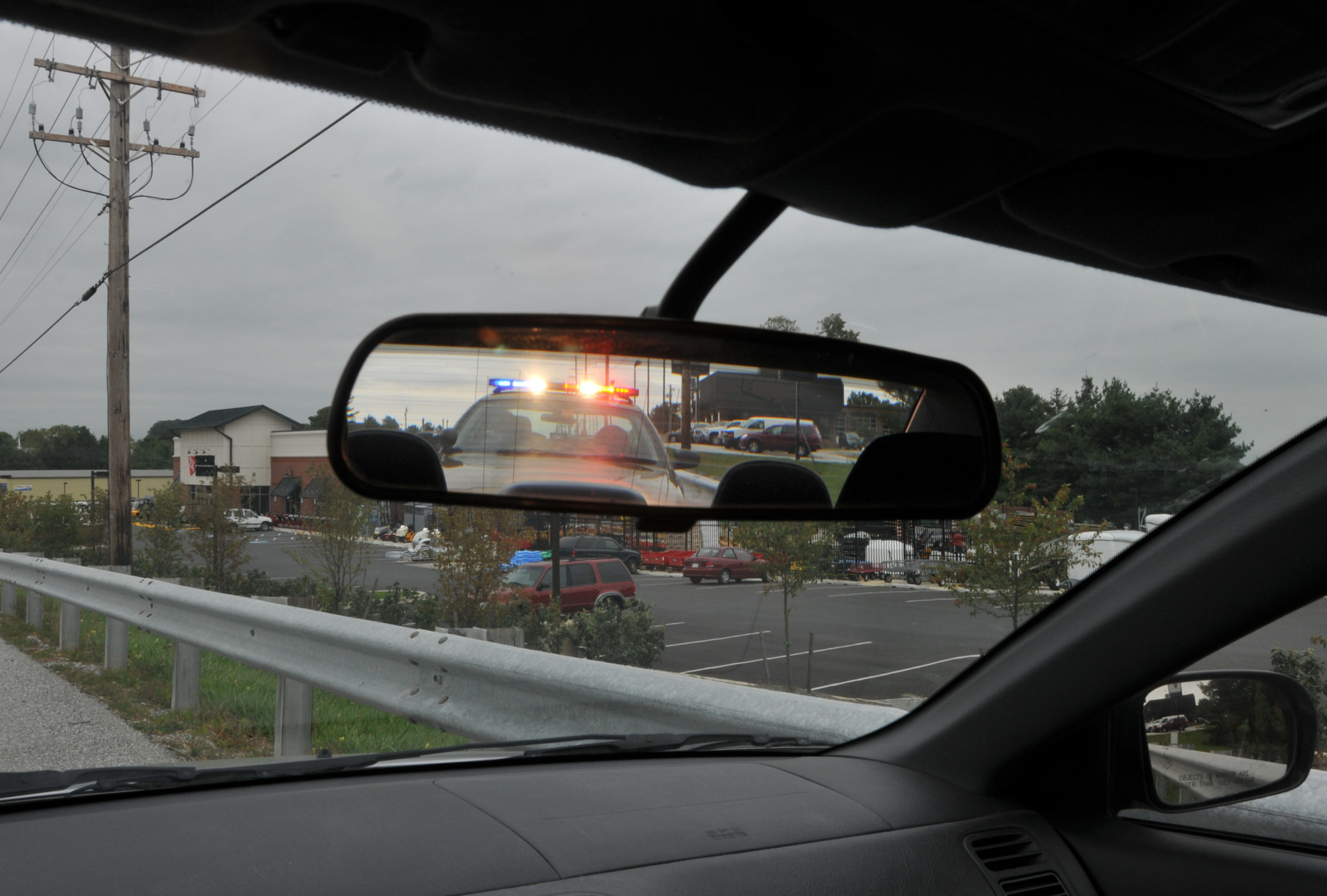 Police car in rear view mirror