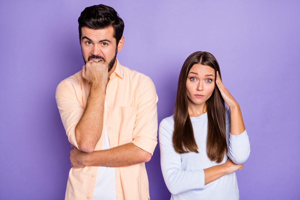 Photo of upset brunette man and woman, conflict break-up, man wearing orange shirt and woman blue pullover 