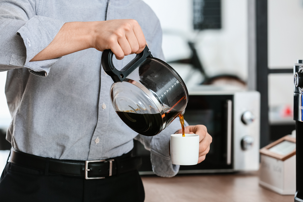 Young man pouring coffee