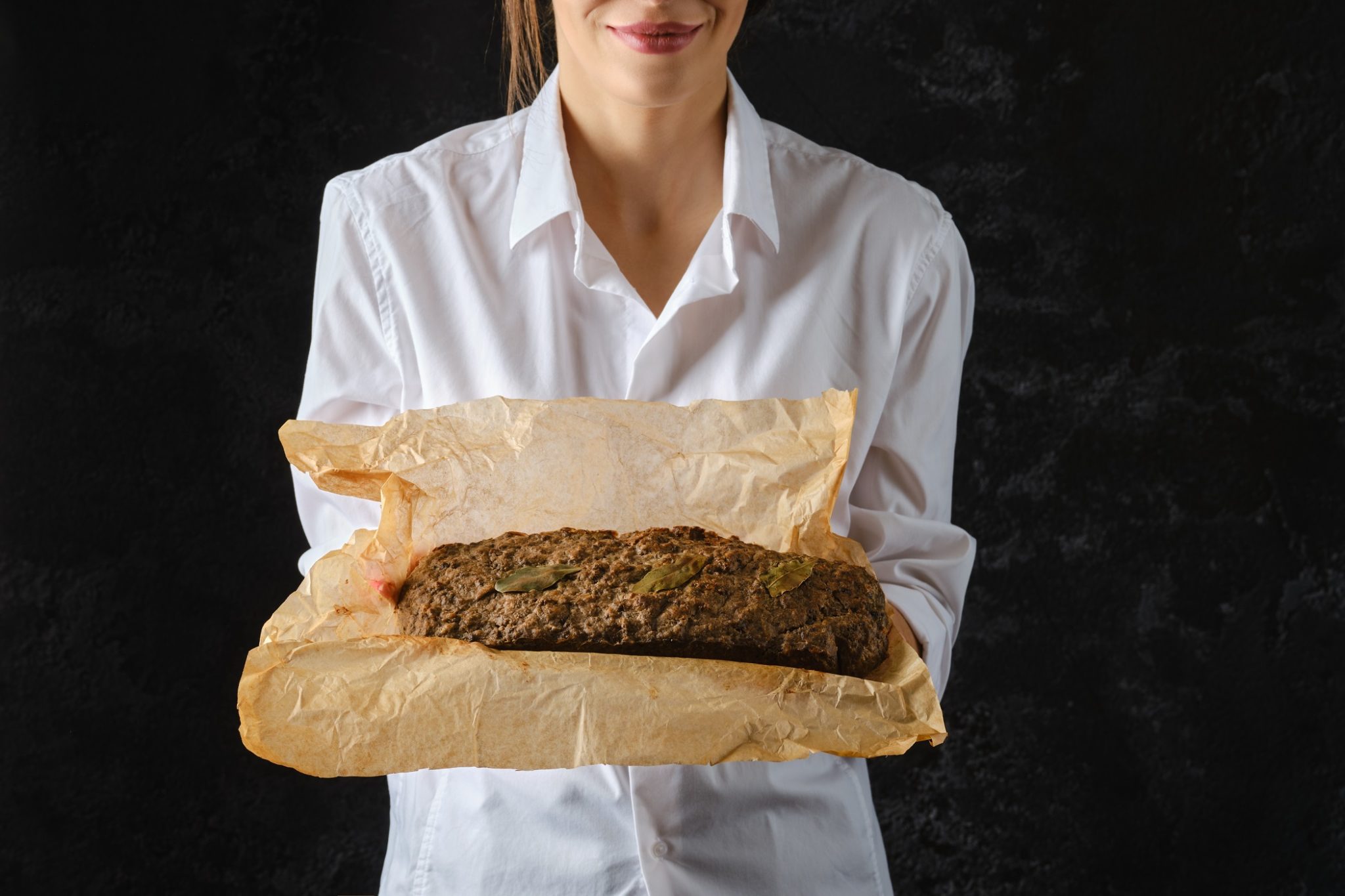 Woman holding a meatloaf