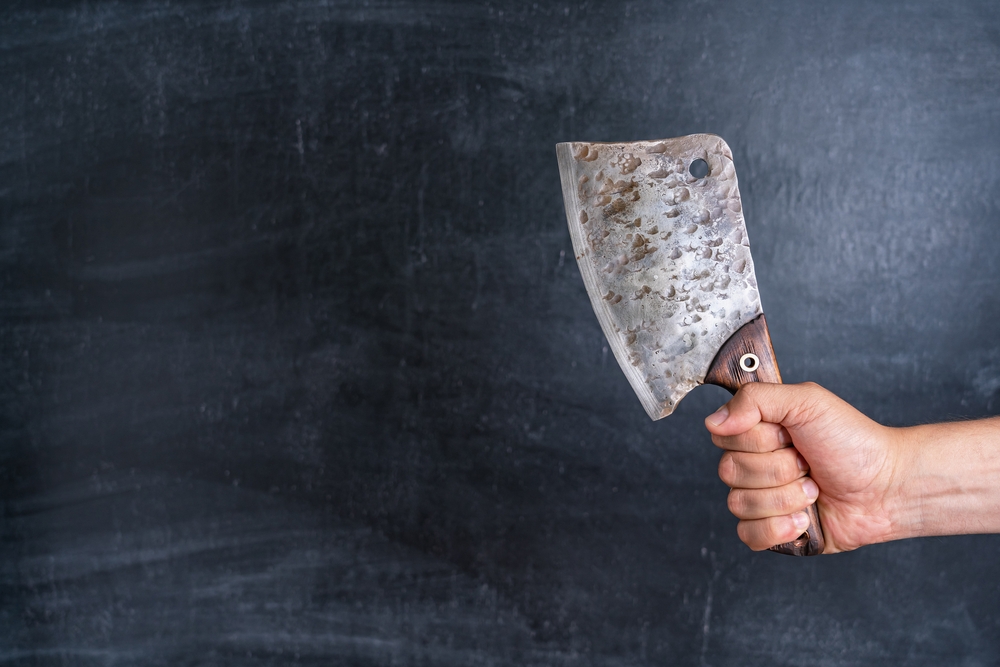 Old kitchen cleaver in man's hand