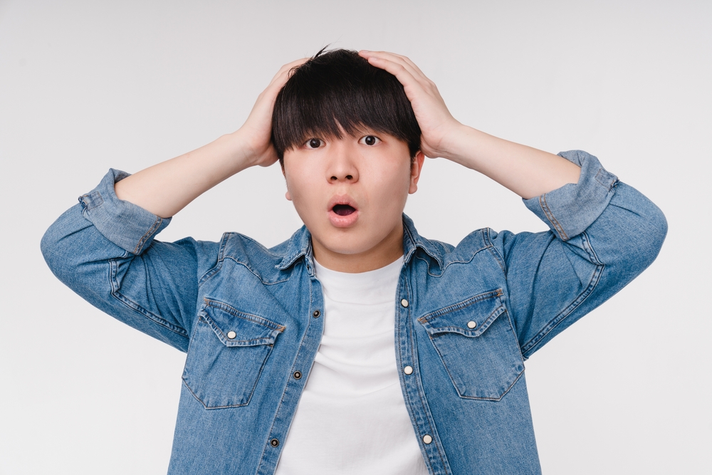 Shocked Korean man looking at the camera 