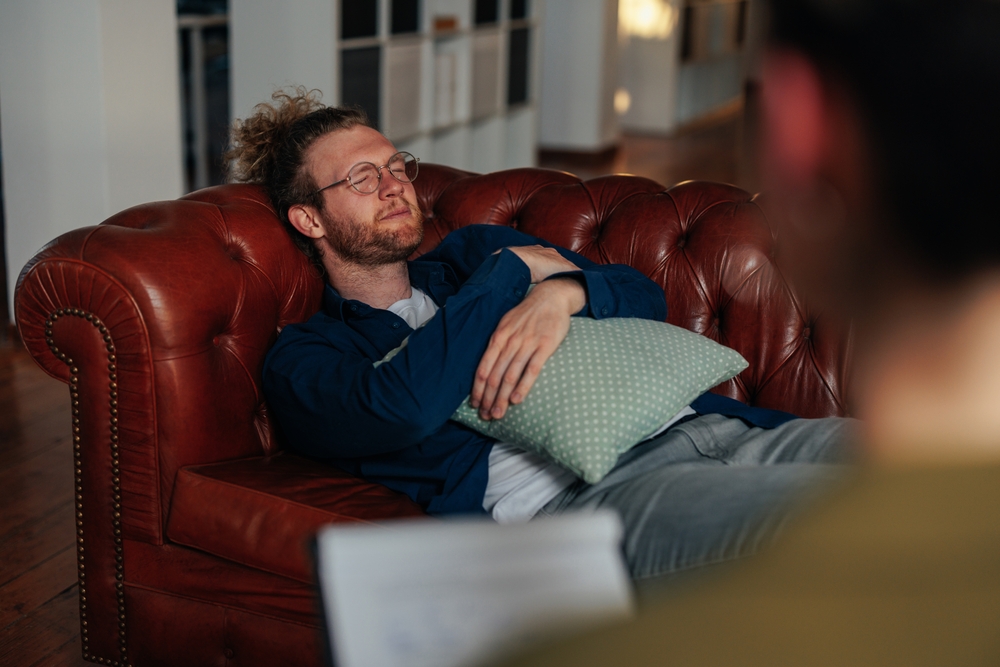 Man on a couch for a session with therapist