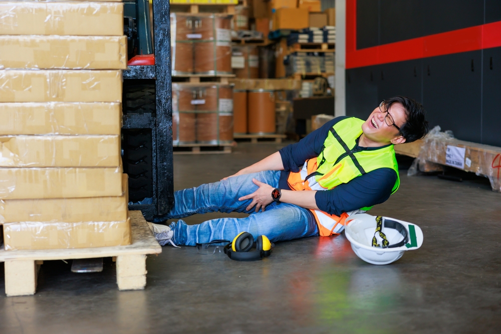 Warehouse man worker lying down on floor after accident