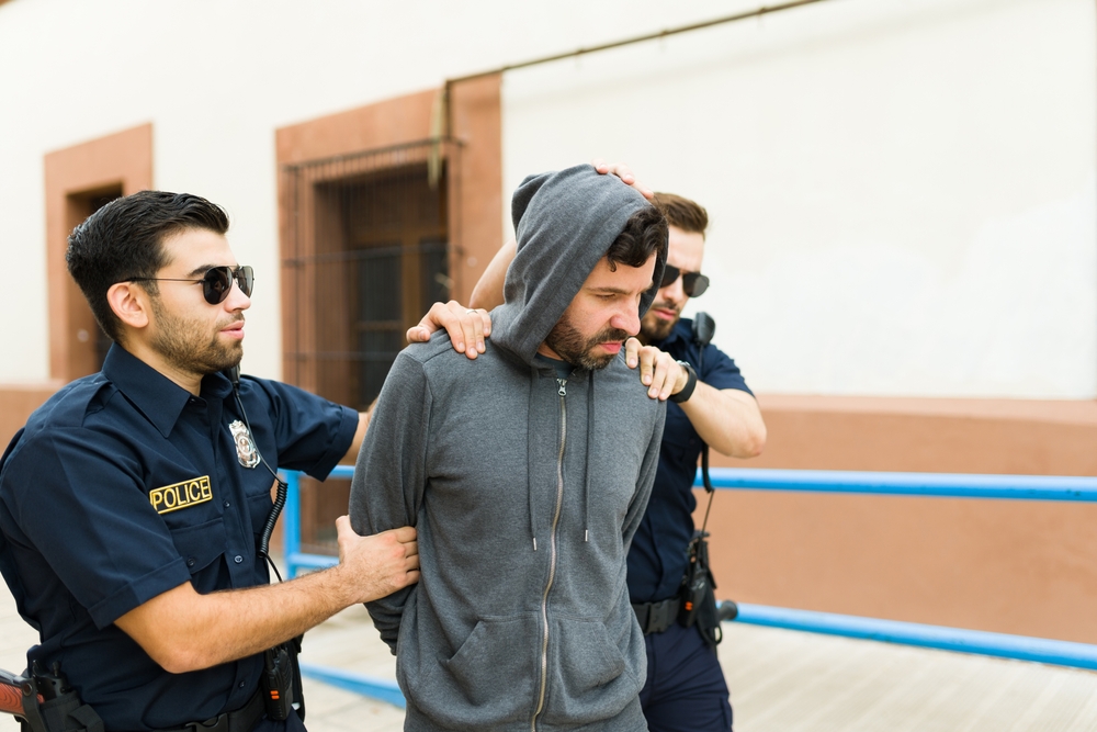 Two cops agents arresting a man