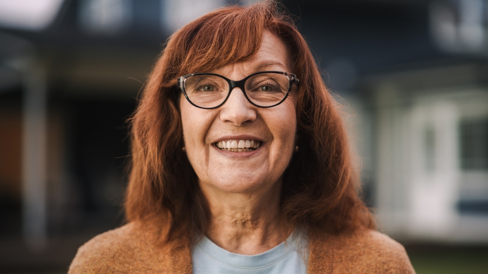 Retired Adult Female Looking at Camera and Smiling