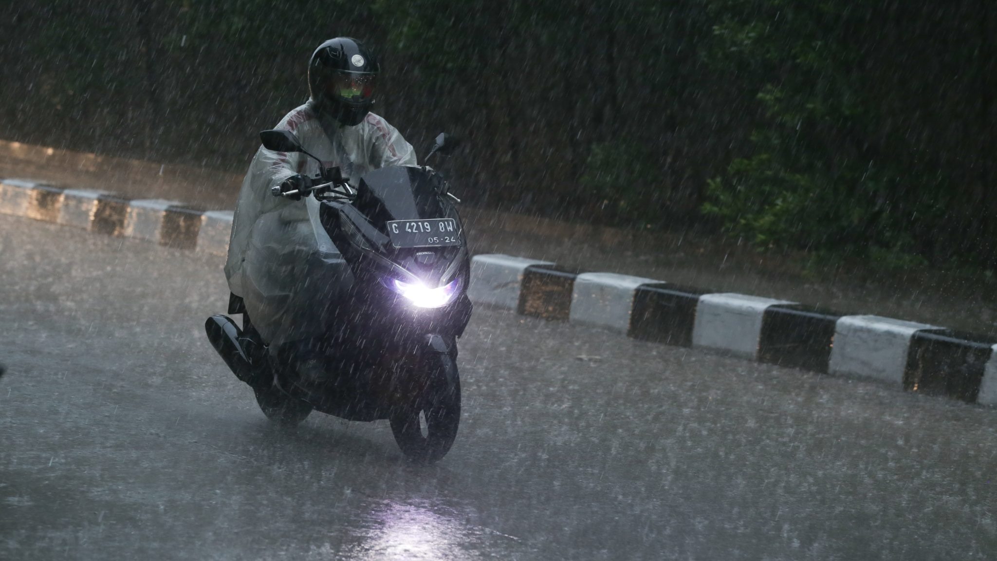 Man riding motorbike in the rain