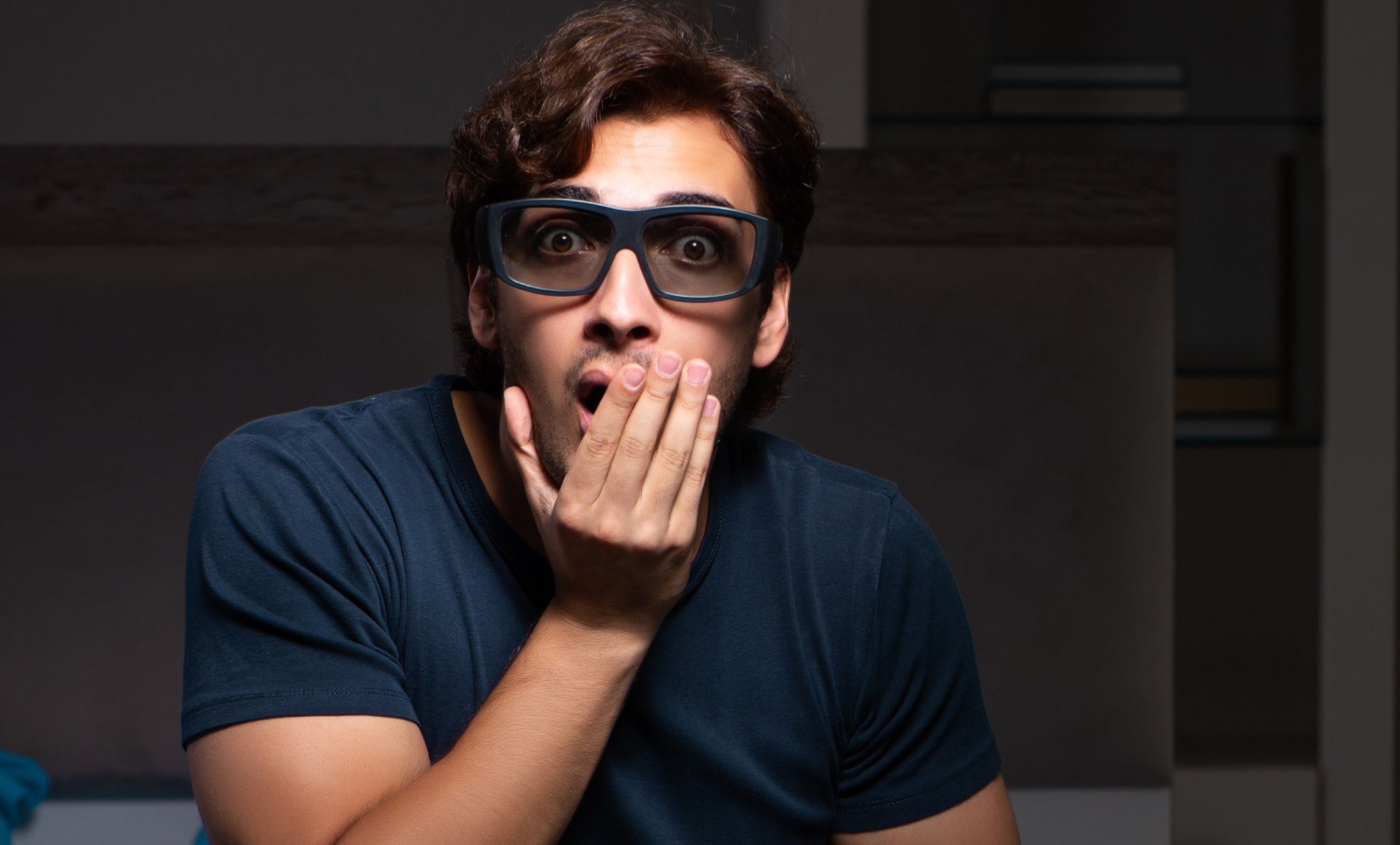 Shocked man just woke up with hand over mouth gesture 