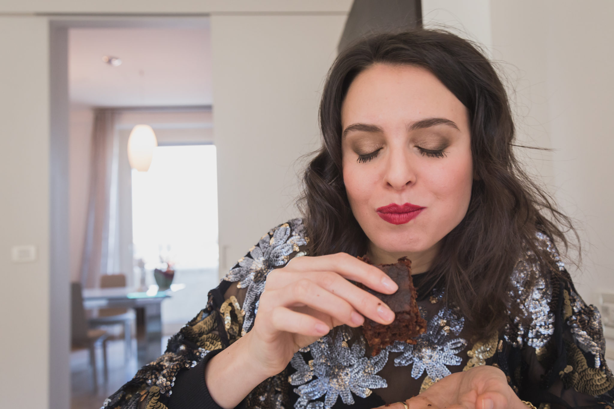 Woman eating brownie.