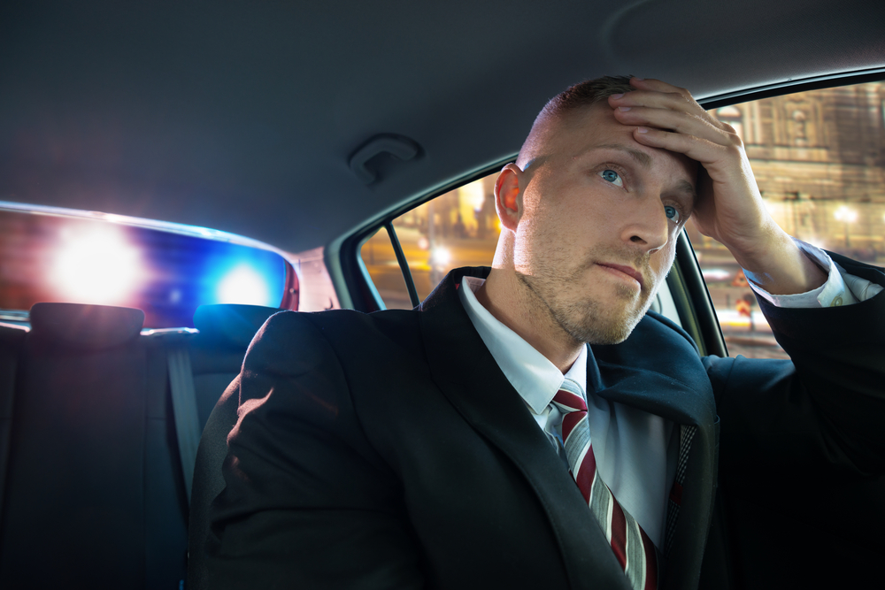Stressed Young Driver wearing a suit stopped by police