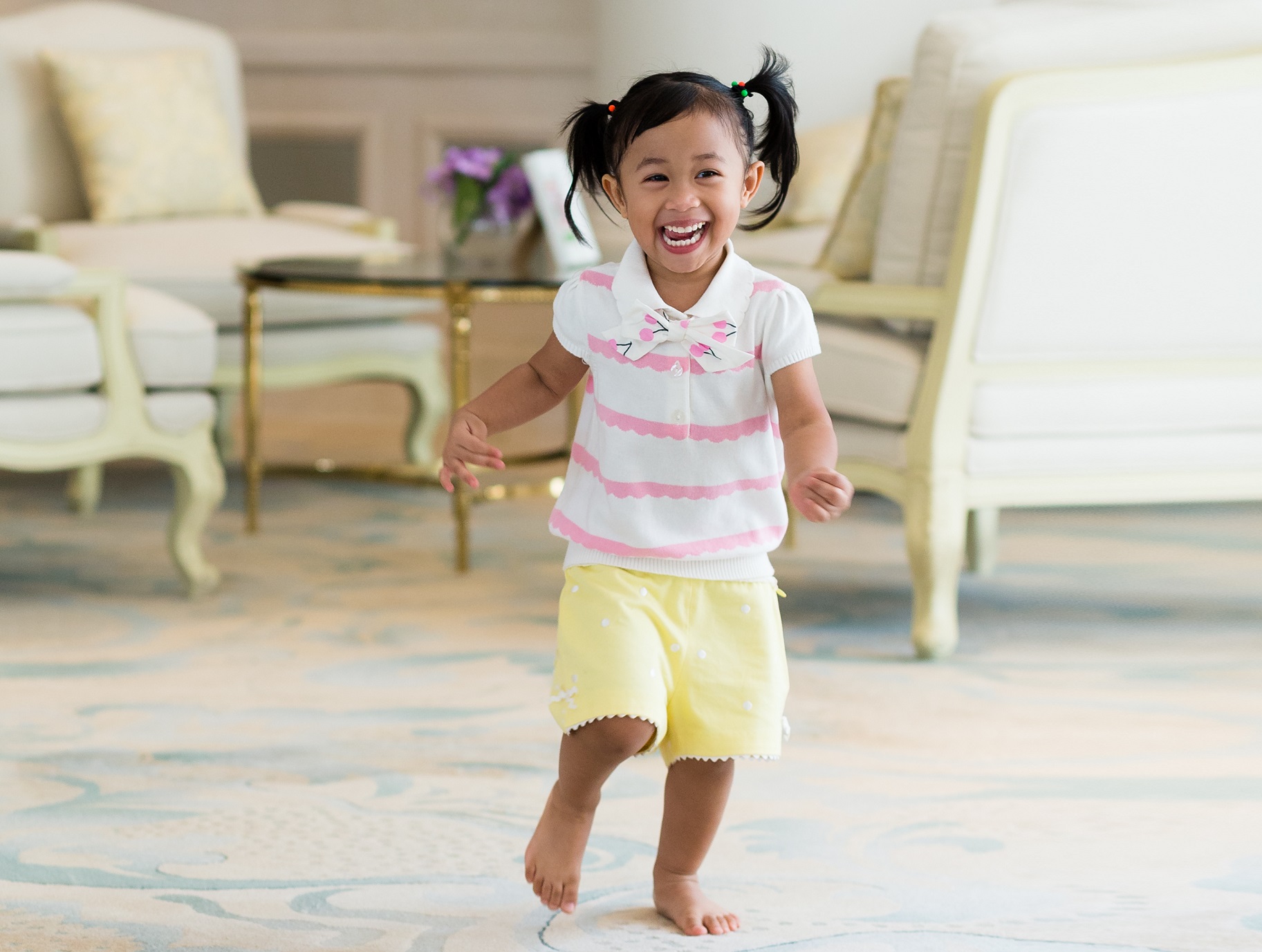 Small girl in white shirt running at home