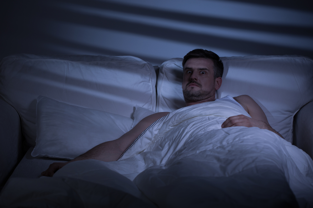 Terrified man in bed woke up