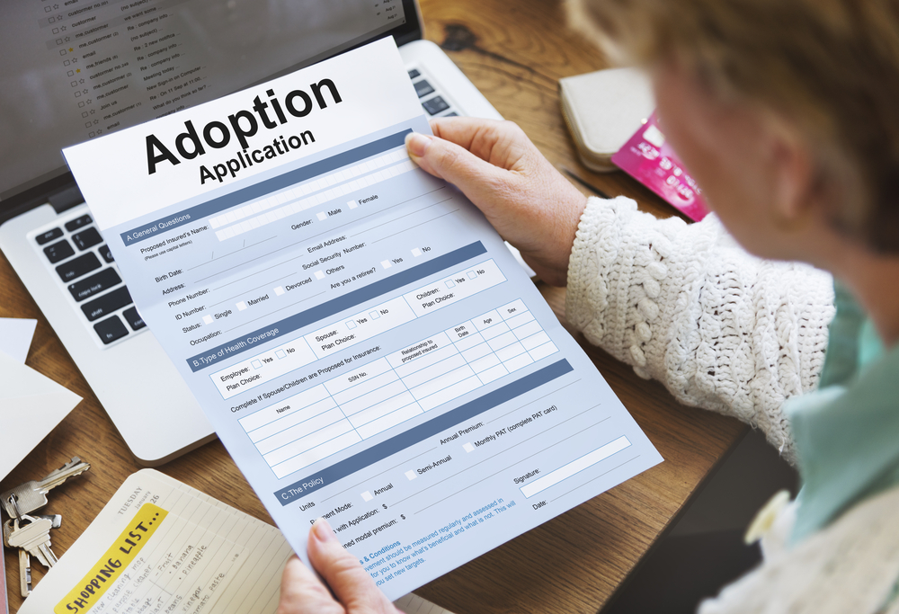 Woman holding Adoption Application
