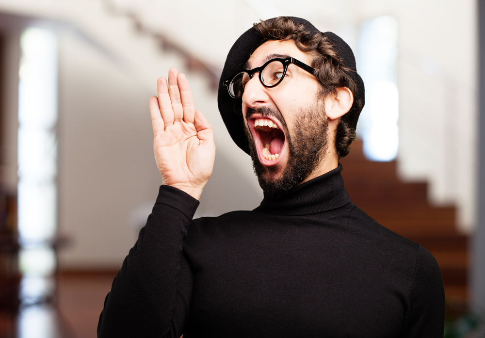 Shocked man on stairs in black turtleneck