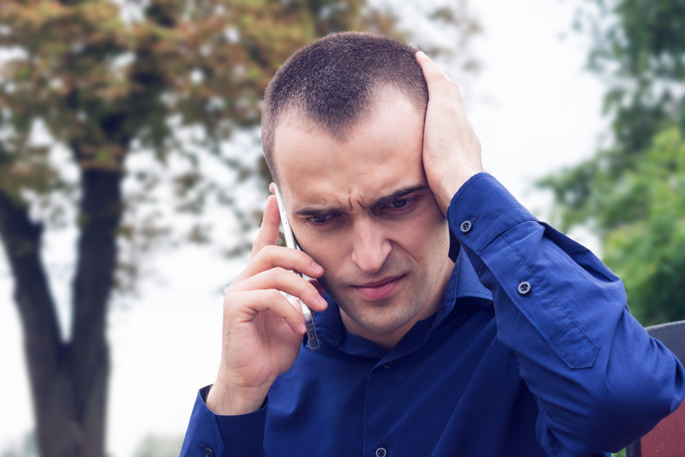 Scared man talking on the phone