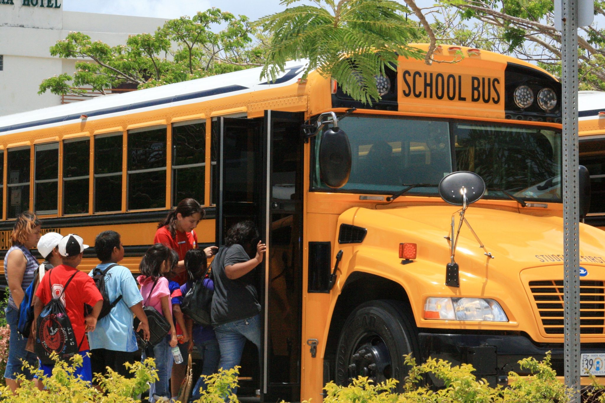 Kids at field trip boarding a school bus