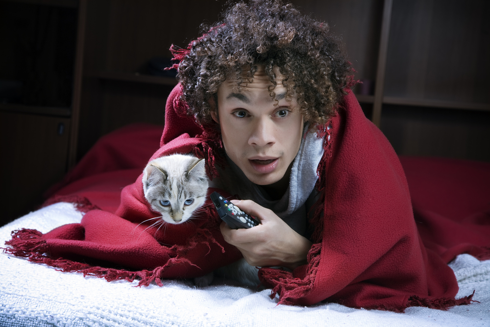 Scared guy holding his scared cat 