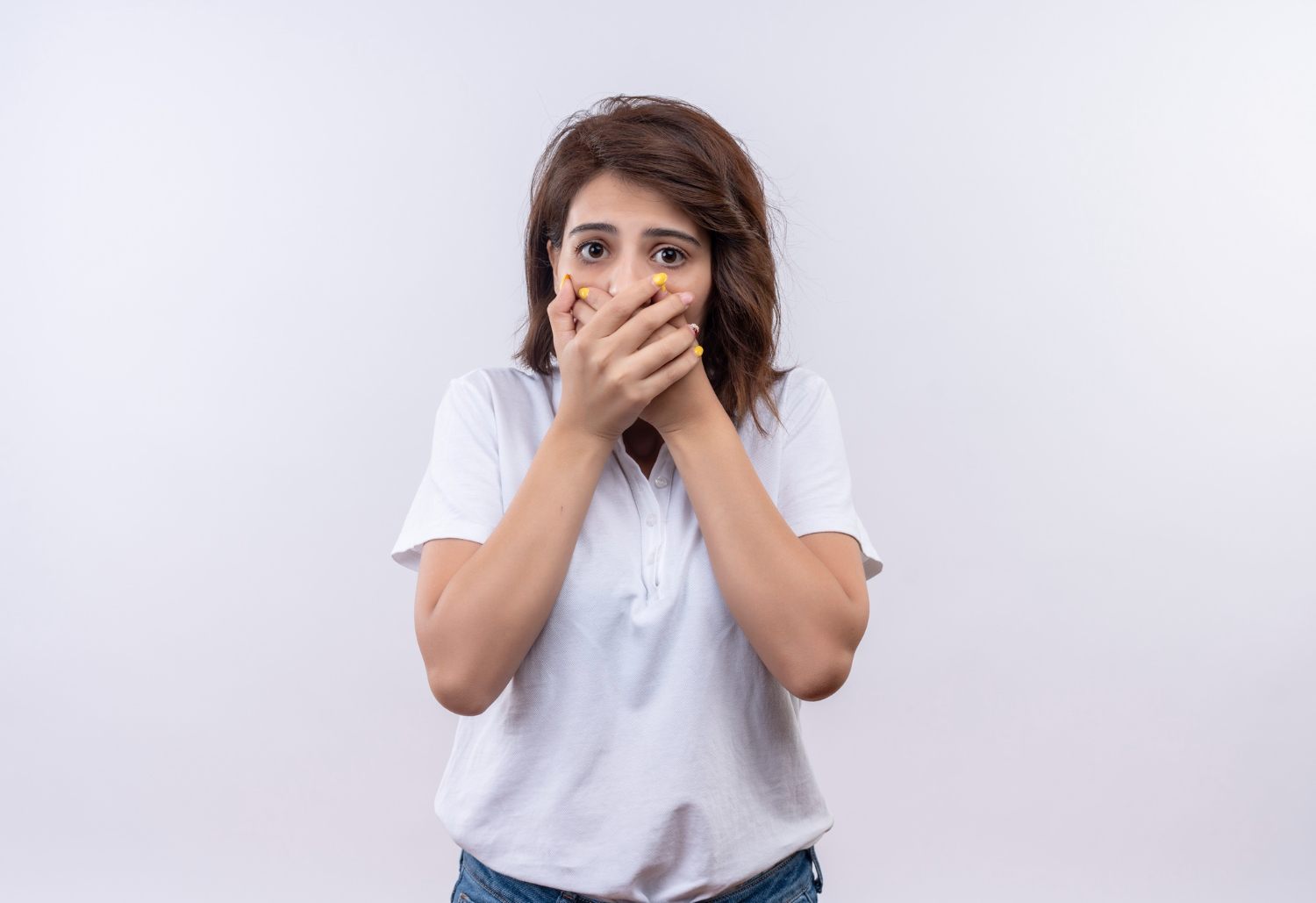 Young woman covering her mouth.