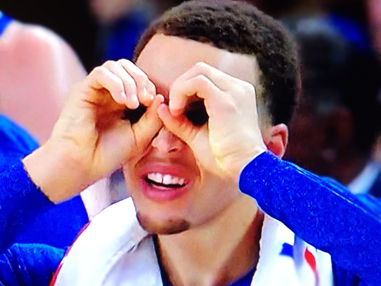 Steph Curry making face at basketball game.