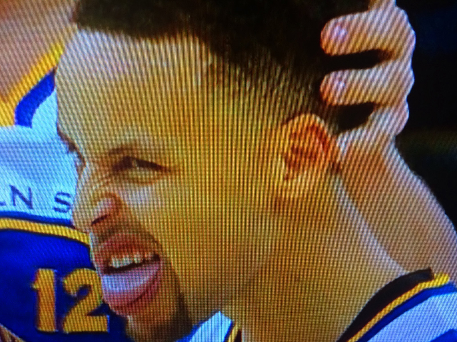 Steph Curry making a face at basketball game.