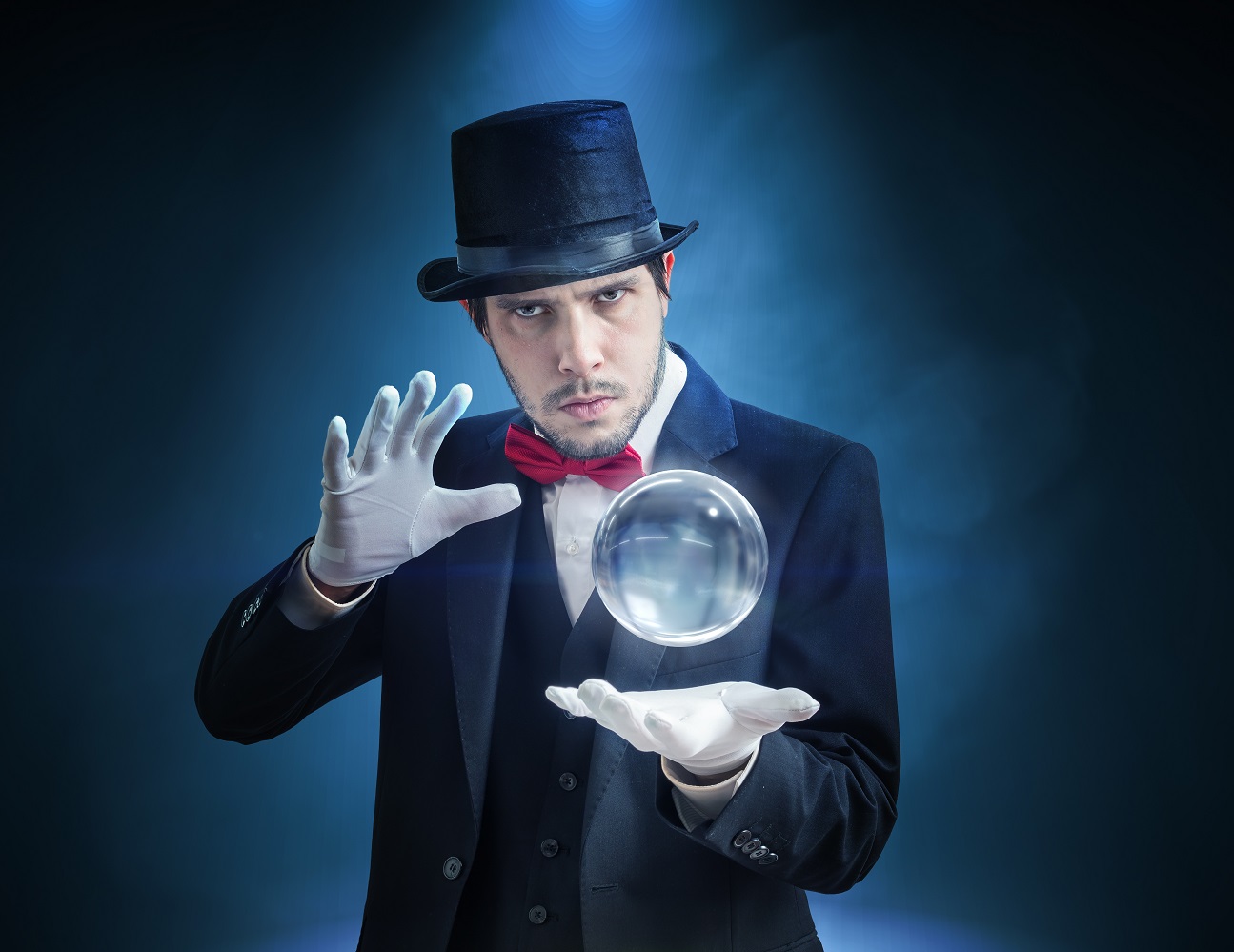 Young illusionist, magician or fortune teller is predicting future with crystal sphere.
