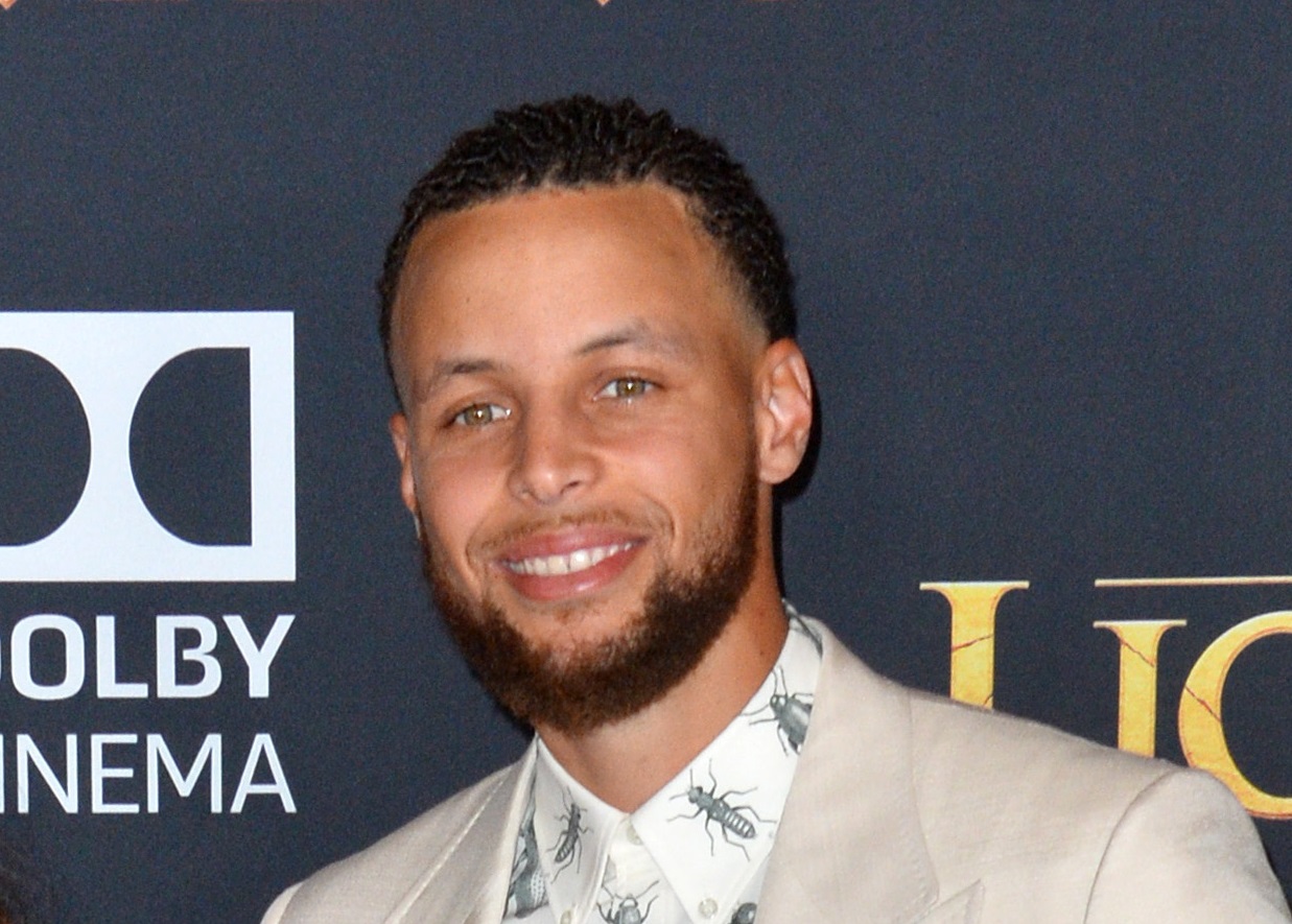 Steph Curry wearing white suit is looking at camera - 2019