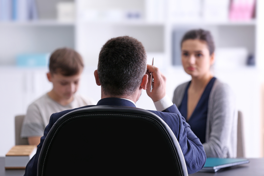 Young woman with son at principal's office
