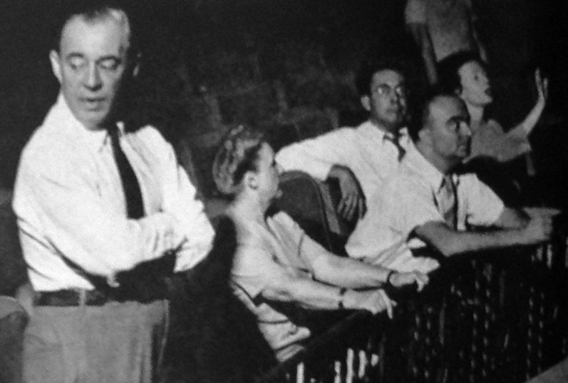 Grayscale photo of Richard Rodgers standing in a theater near other people