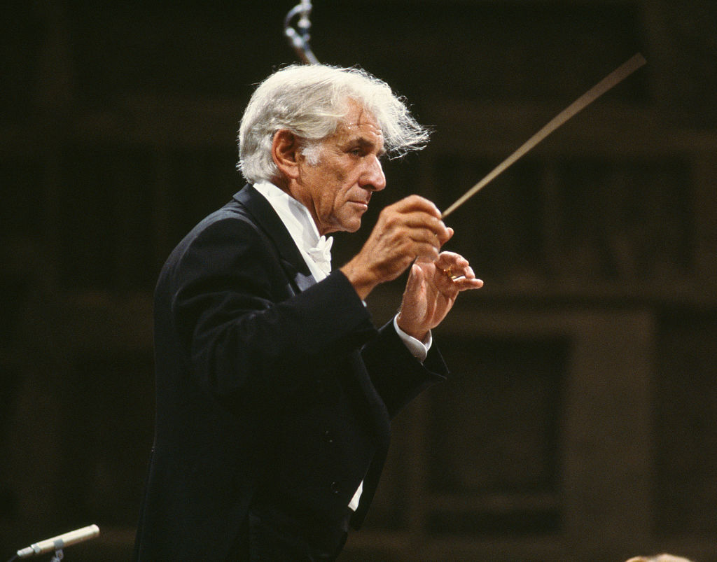 American Composer Leonard Bernstein conducts an orchestra