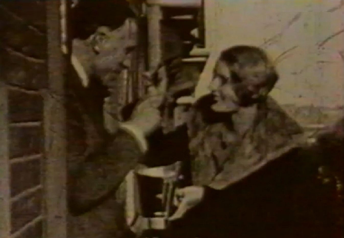 Screenshot: B&W Lee Miller is smiling and talking with other person - from Lee Miller: Through the Mirror (1955)
