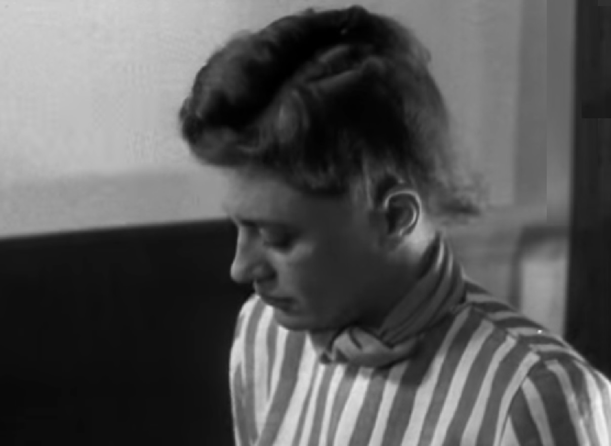Screenshot: B&W Lee Miller is looking down with sad face - from Lee Miller: Through the Mirror (1955)