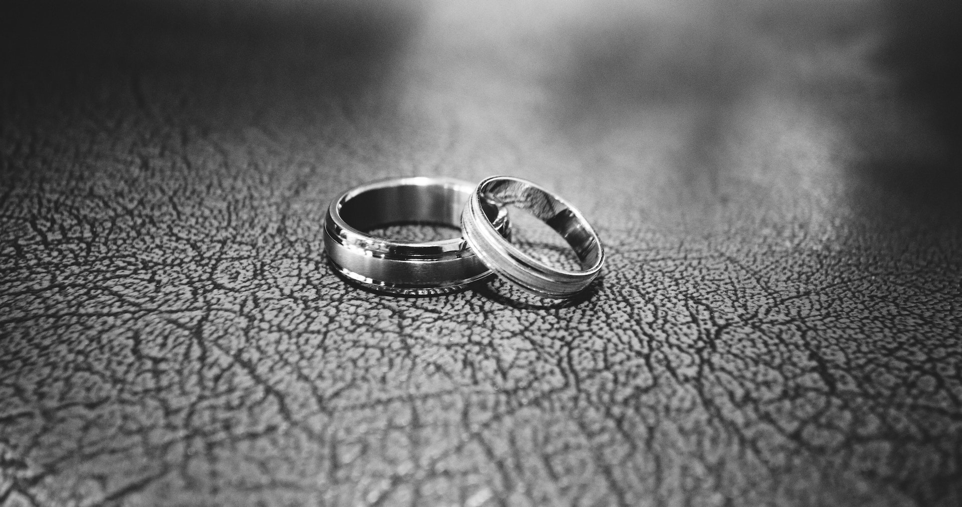 grayscale close up photo of wedding rings