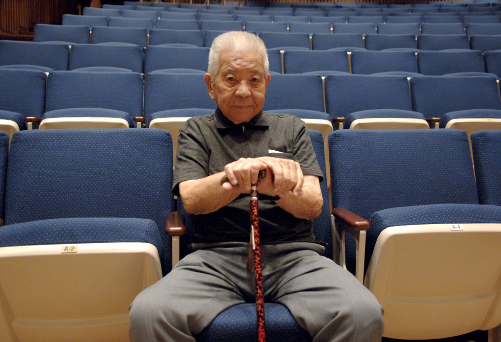 Tsutomu Yamaguchi, survivor of the bombings of Hiroshima and Nagasaki sitting in a theatre