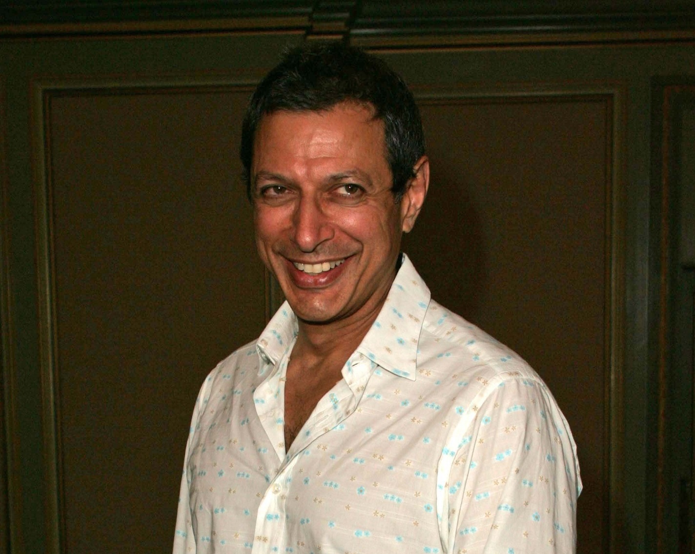 Jeff Goldblum wearing white shirt is smiling at side - 2006