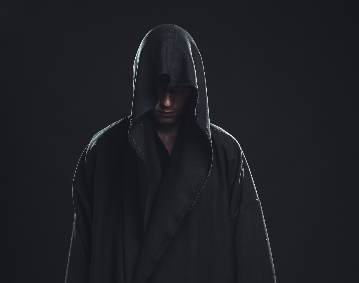 Portrait of a Man in a black robe on a dark background