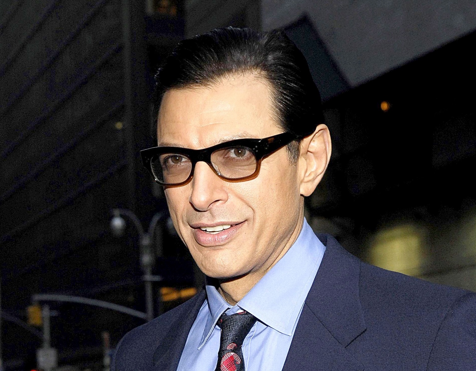 Jeff Goldblum in black suit is looking at side and smiling - 2007