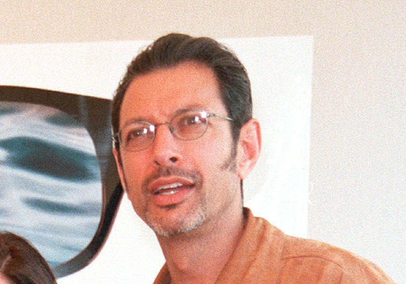 Jeff Goldblum wearing brown jacket is looking at side - 1999