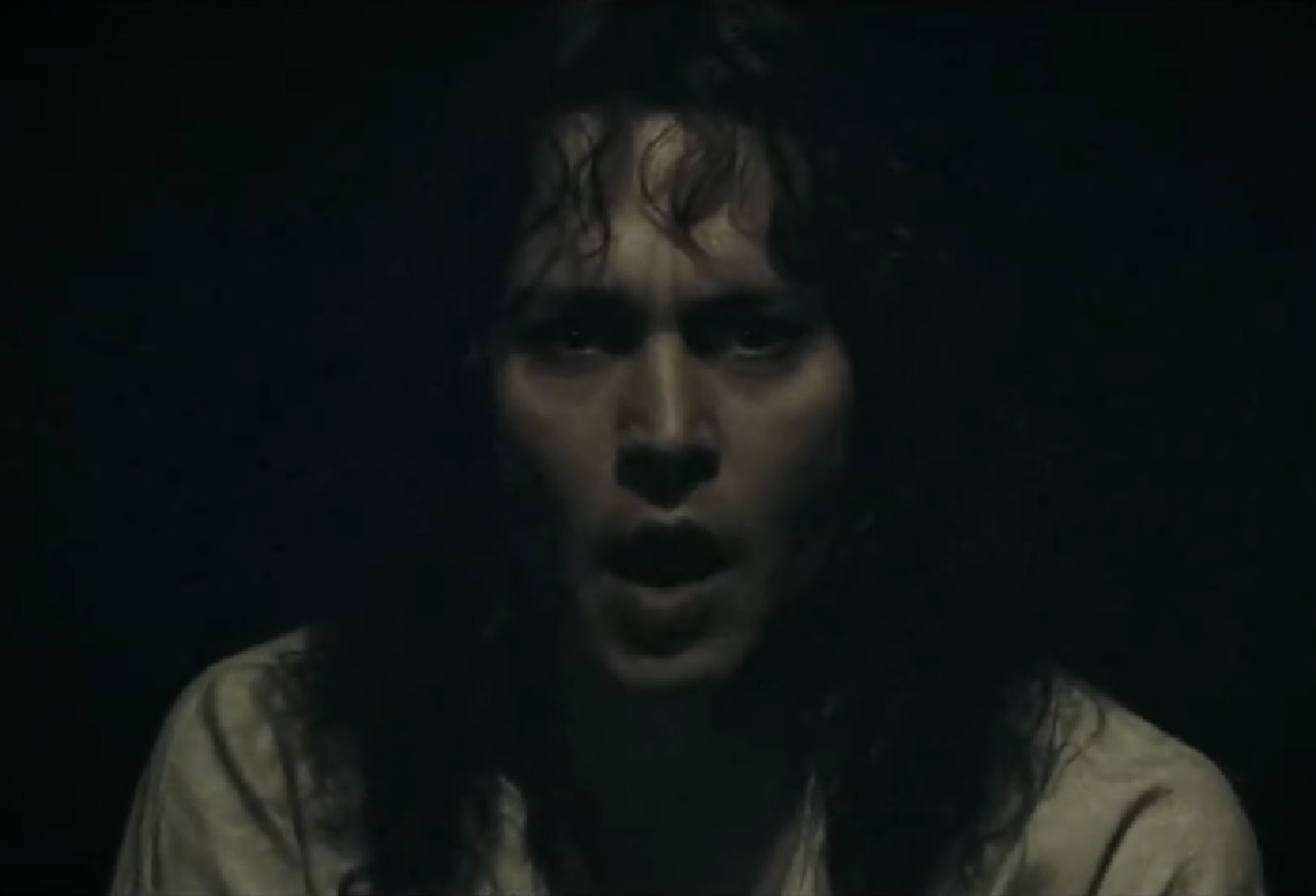 Screenshot: Jonny Deep with long hair wearing white shirt is looking at front - from The Libertine (2004)