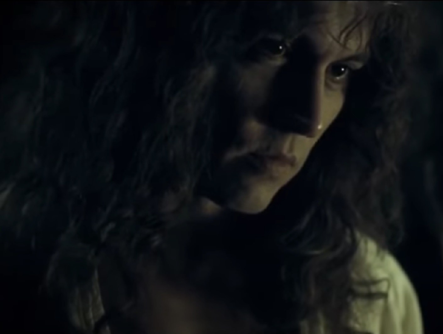 Screenshot: Johnny Deep with long hair wearing white shirt is looking at side - from The Libertine (2004)