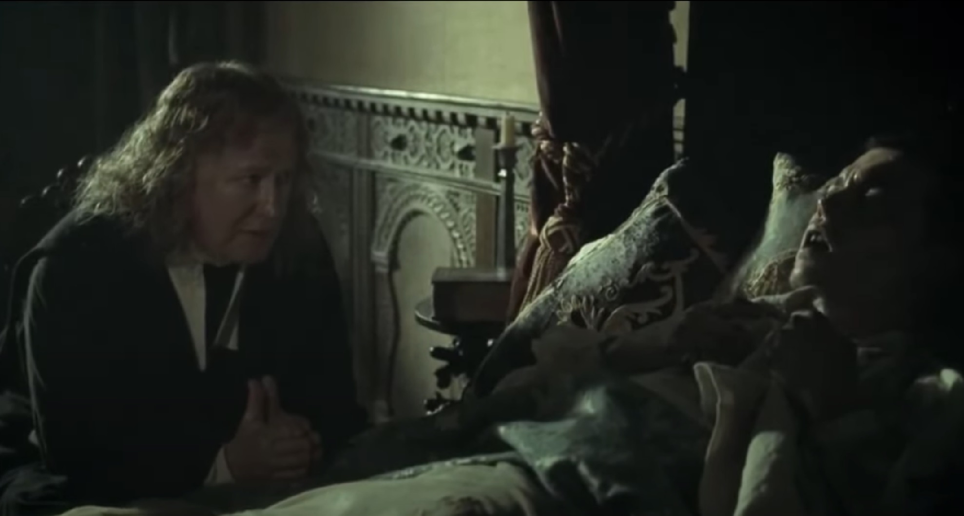 Screenshot: Johnny Deep is laying in the bed at dark room - from The Libertine (2004)