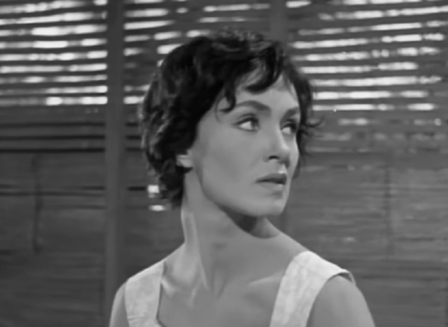 Screenshot: Susan Cabot wearing white dress is looking at side - from Surrender - Hell! (1959)