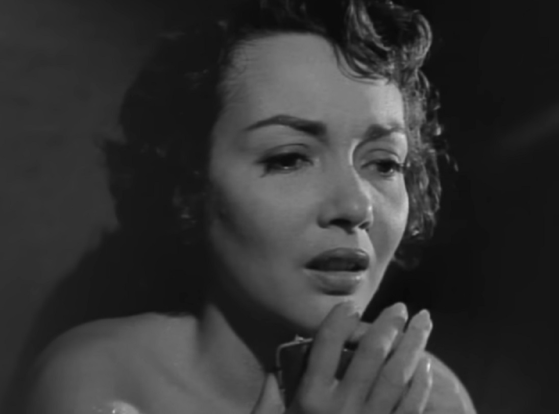 Screenshot: Susan Cabot with messy hair is looking at side - from Surrender - Hell! (1959)
