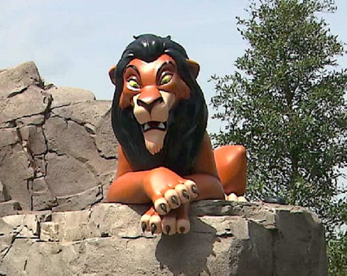 Scar toy from lion king in the rocks.