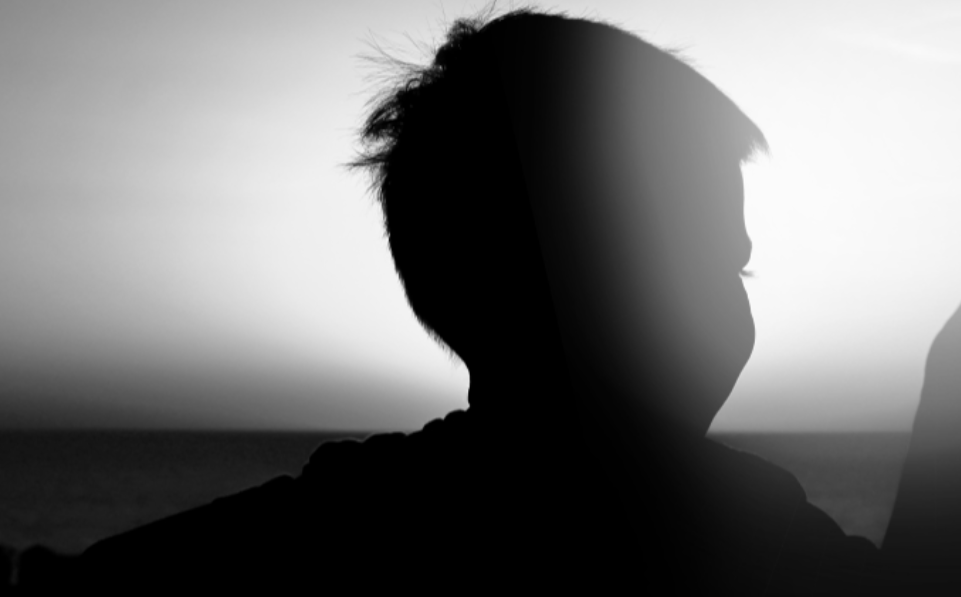 Child outside at sunset