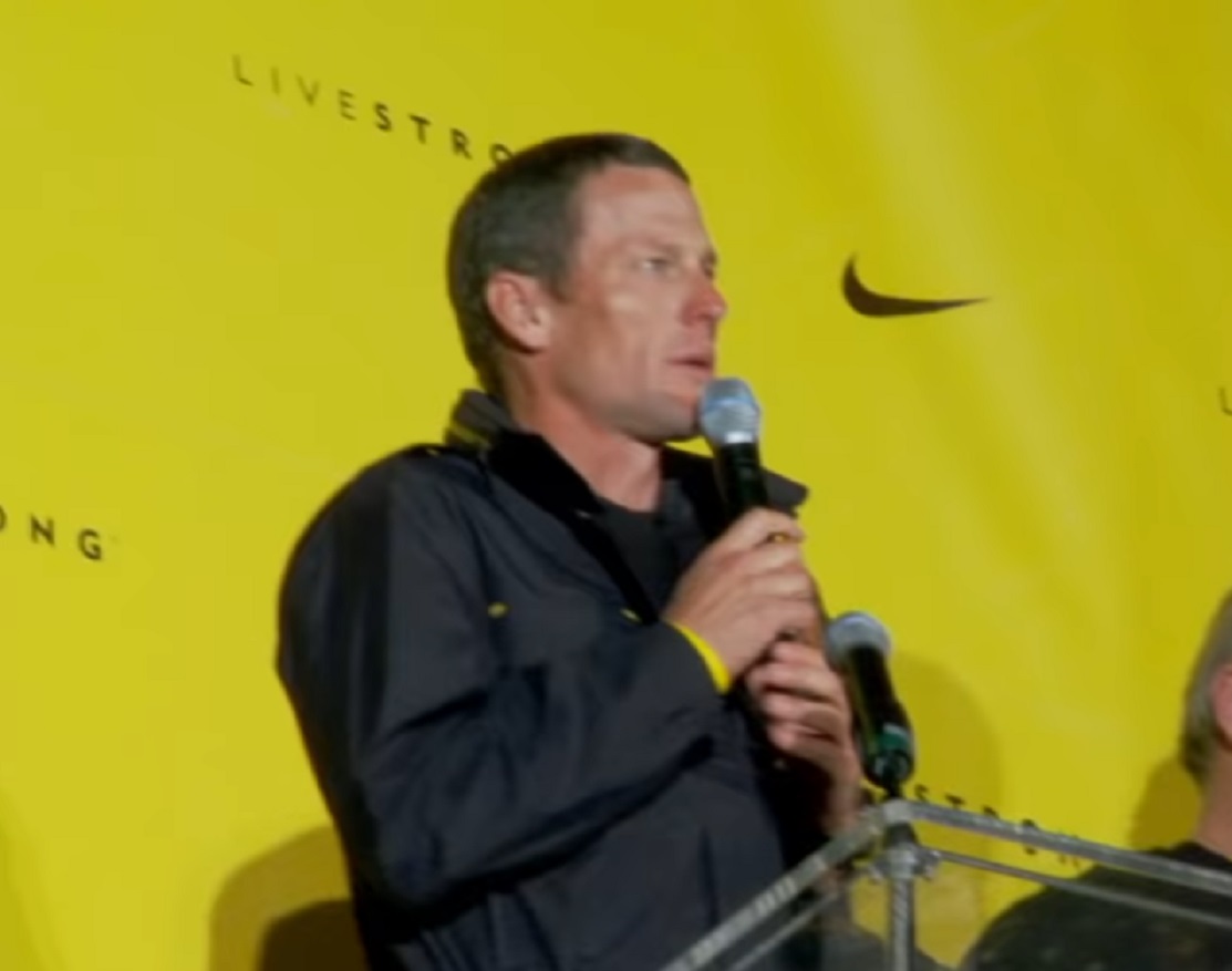 Screenshot: Lance Armstrong talking on the mike - from Stop At Nothing- The Lance Armstrong Story (2014)