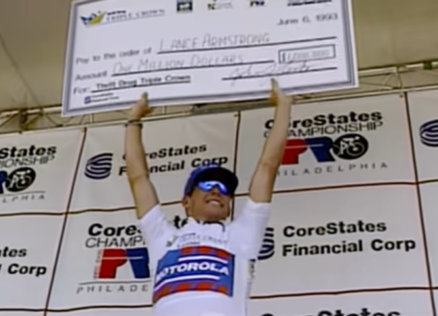 Screenshot: Lance Armstrong is holding a winner's check - from Stop At Nothing- The Lance Armstrong Story (2014)