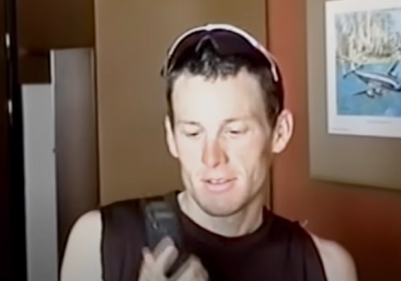 Lance Armstrong is looking at phone - from Stop At Nothing- The Lance Armstrong Story (2014)
