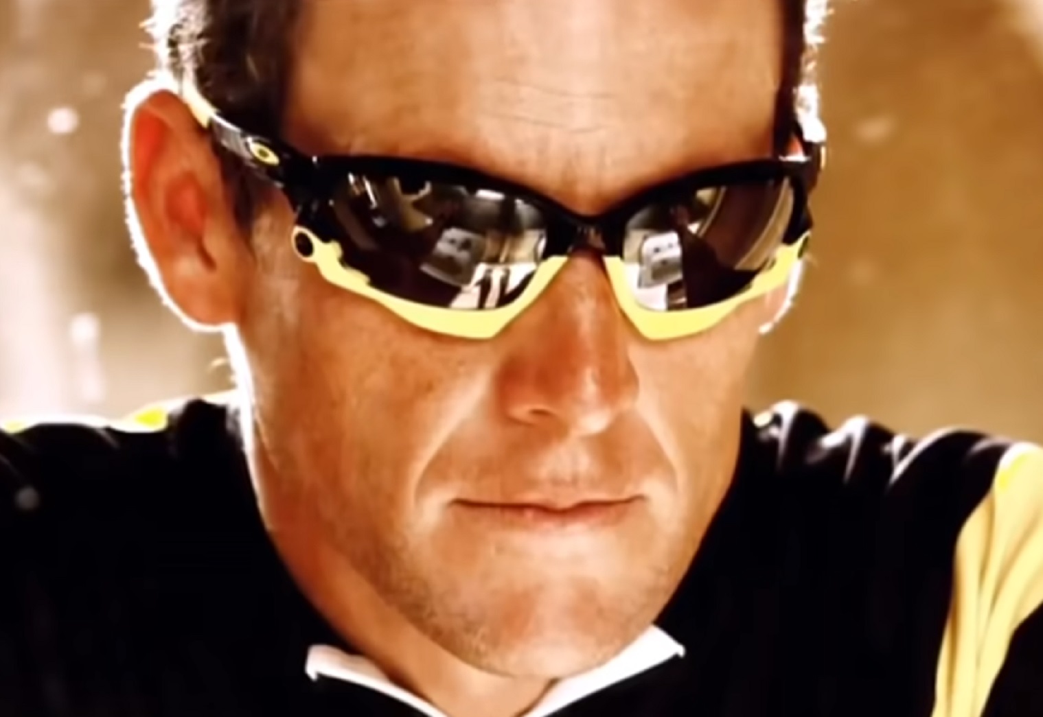 Screenshot: Lance Armstrong wearing sunglasses is looking at front - from Stop At Nothing- The Lance Armstrong Story (2014)