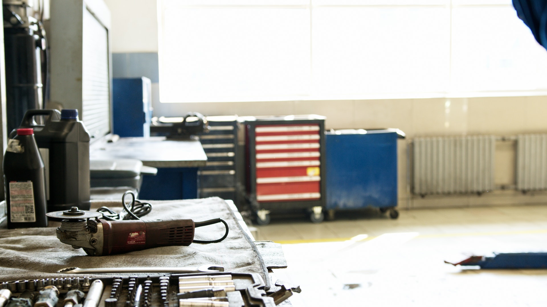 angle grinder power placed on a work desk tool near a toolbox in a working room