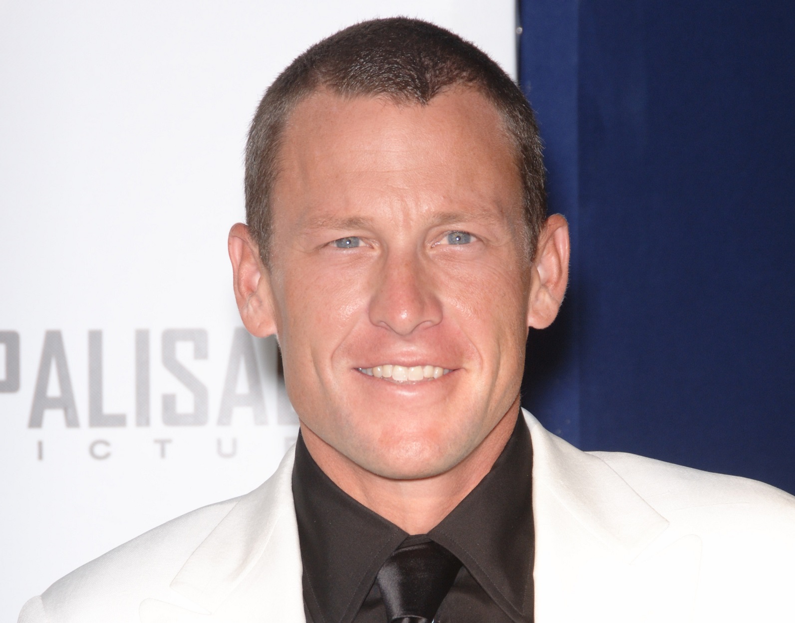 Lance Armstrong wearing black suit is smiling at camera - 2006